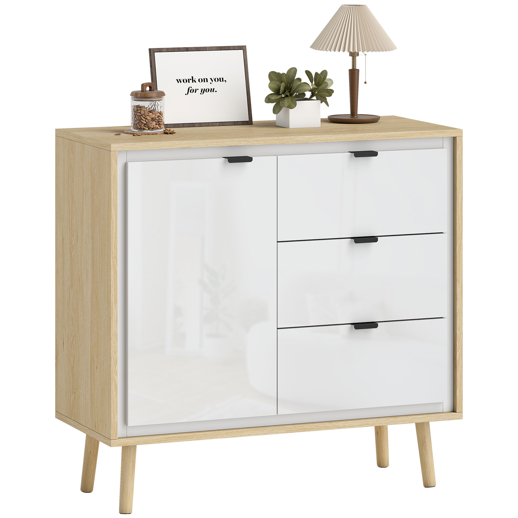 Una credenza in legno chiaro con ante e cassetti bianchi, decorata con lampada e pianta.