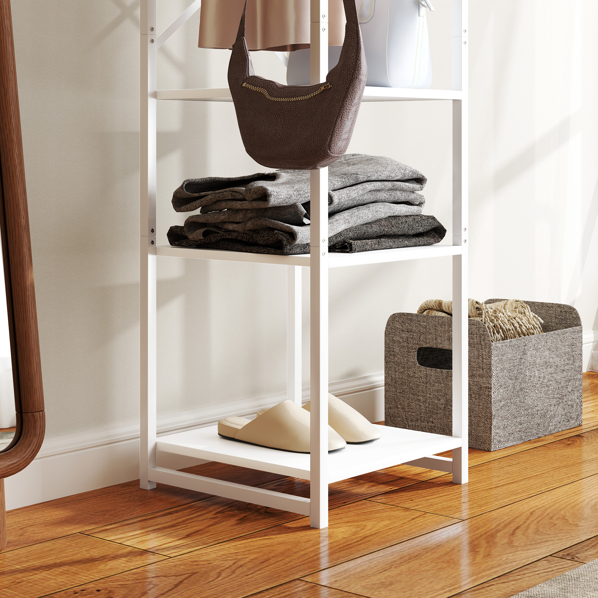 Scaffale bianco con vestiti piegati, borsa marrone, pantofole beige e cesto.