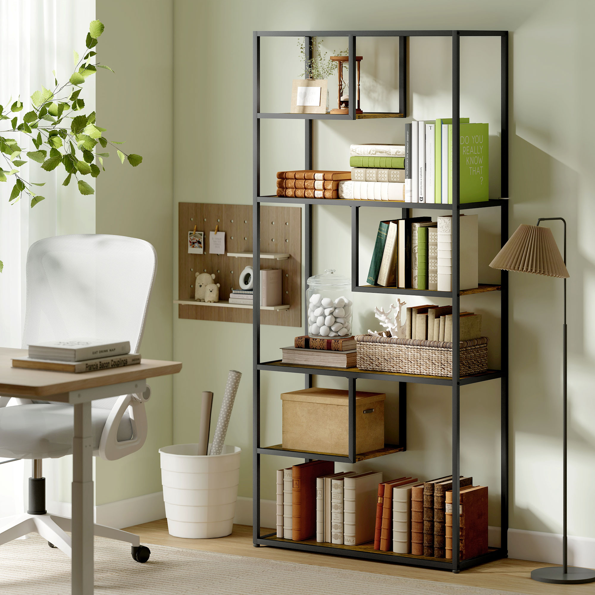 Una stanza verde chiaro con scrivania, sedia bianca, libreria e libri.