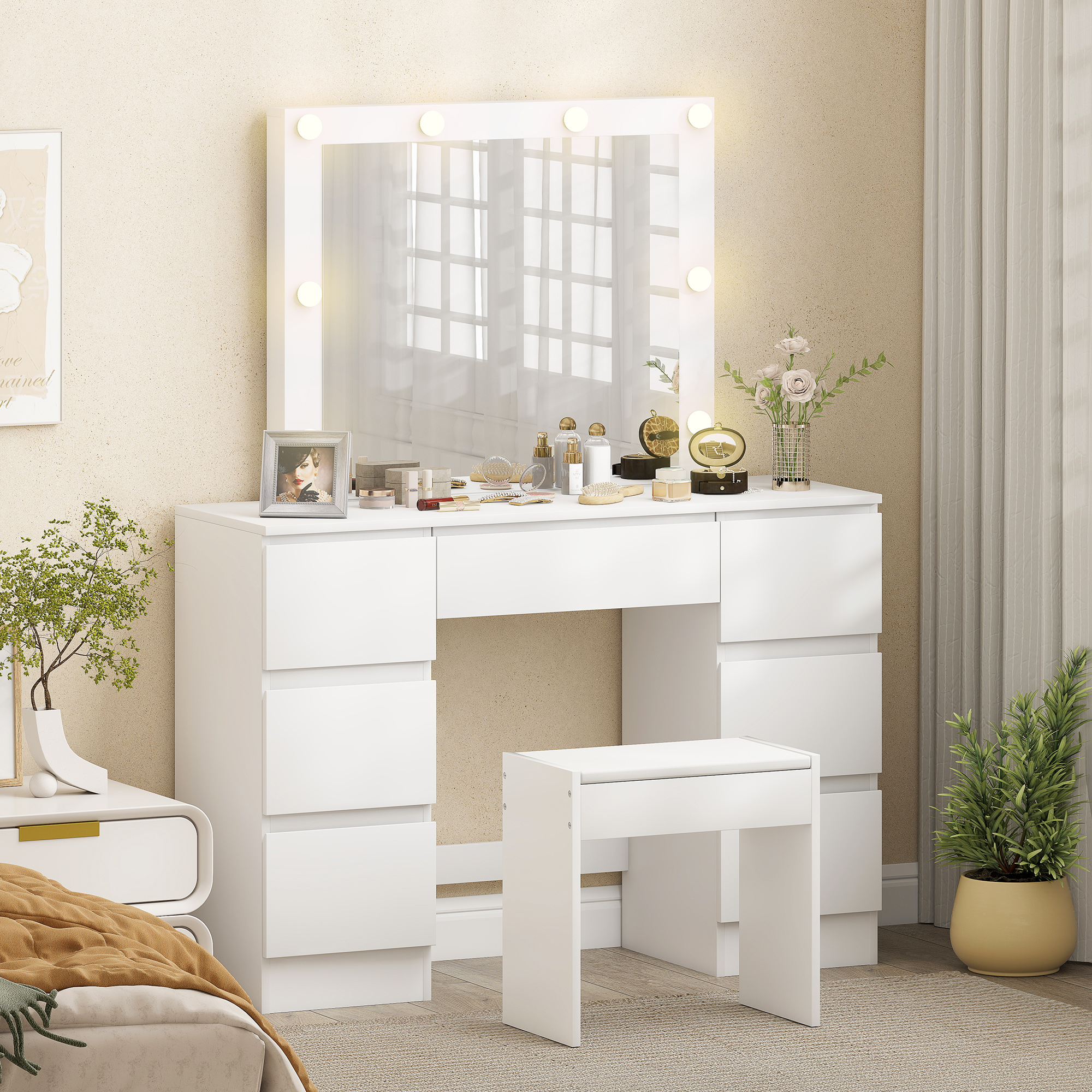 Un mobile da trucco bianco con specchio illuminato, cassetti e sgabello.