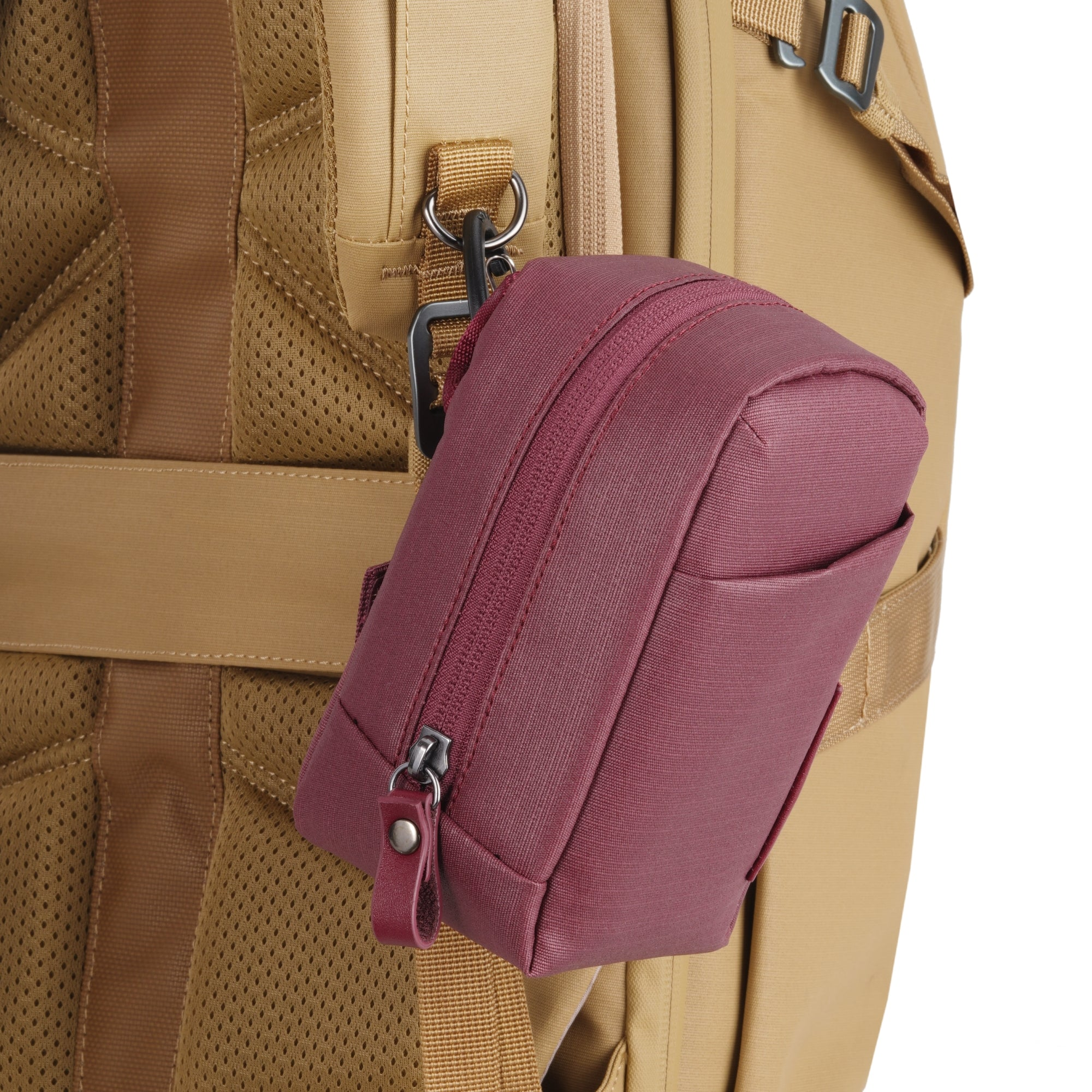 Una bolsa de color burdeos cuelga de una mochila de tela beige con detalles de malla.
