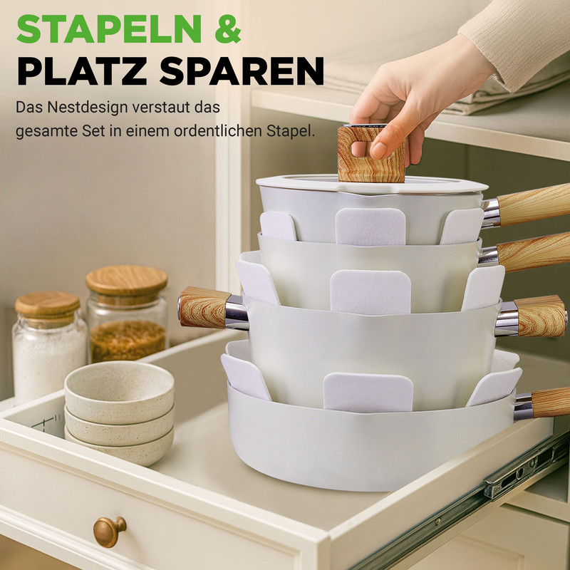 Ein Satz weißer Töpfe mit Holzgriffen, gestapelt in einer Schublade.
