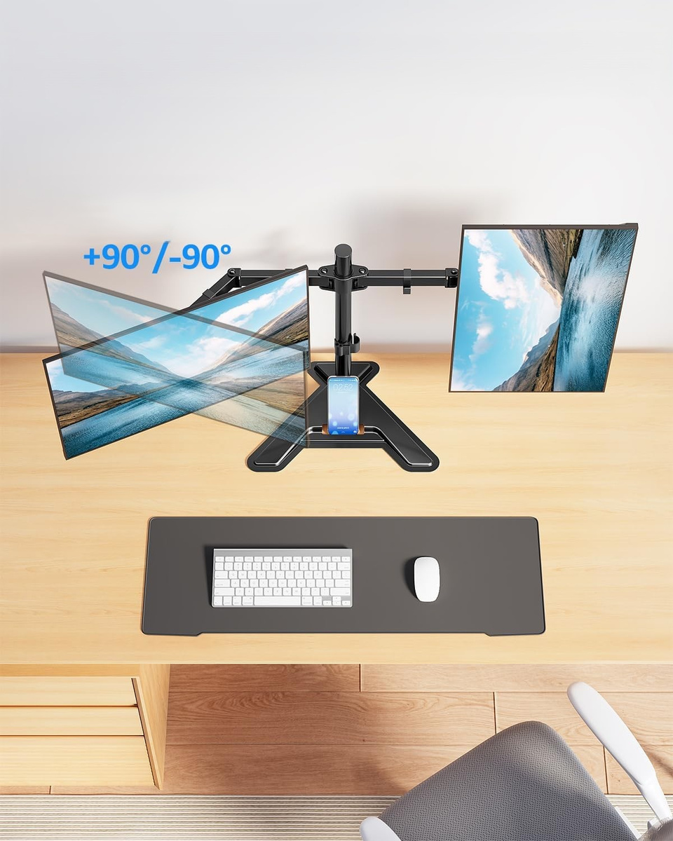 Biurko z dwoma monitorami na stojaku, klawiaturą, myszą i telefonem.
