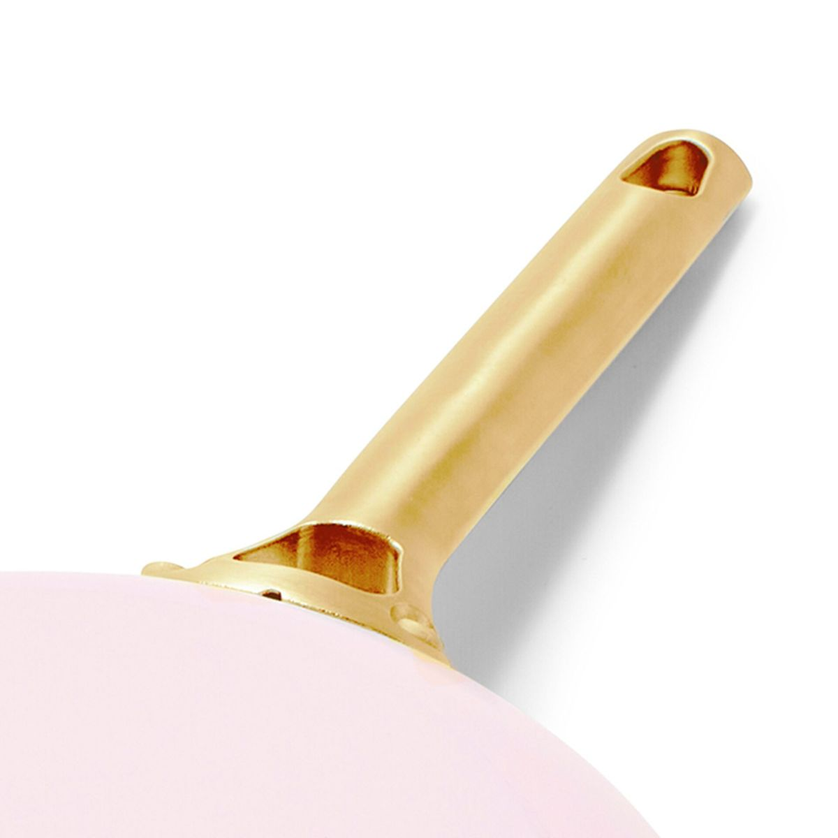 Ein goldener Griff mit einem Loch am Ende auf einer rosa Oberfläche.