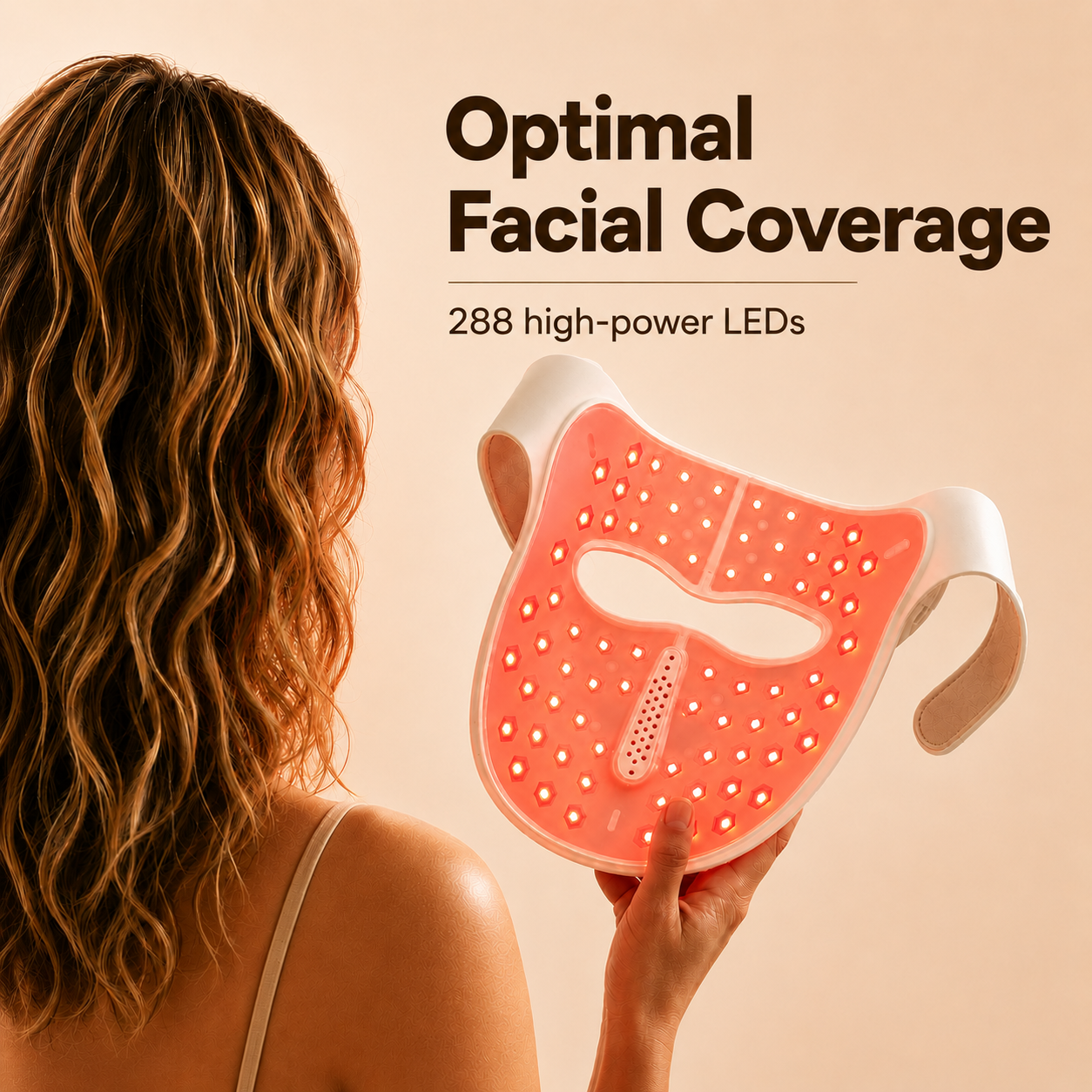 A woman holds a facial mask with red LEDs, designed for skin treatment.