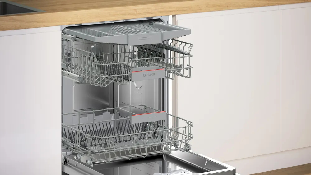 Built-in dishwasher with two pull-out racks, silver, under a wood countertop.