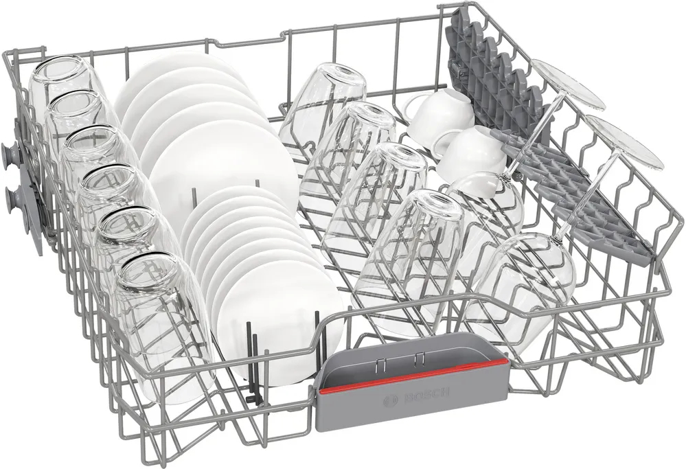 Dishwasher rack filled with glasses, plates and cups, ready for a wash cycle.