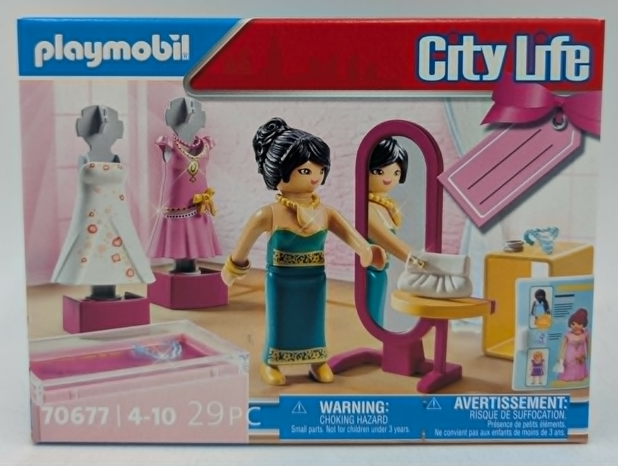 Playmobil-Spielzeug mit Puppen und Kleidern auf einer Verpackung.