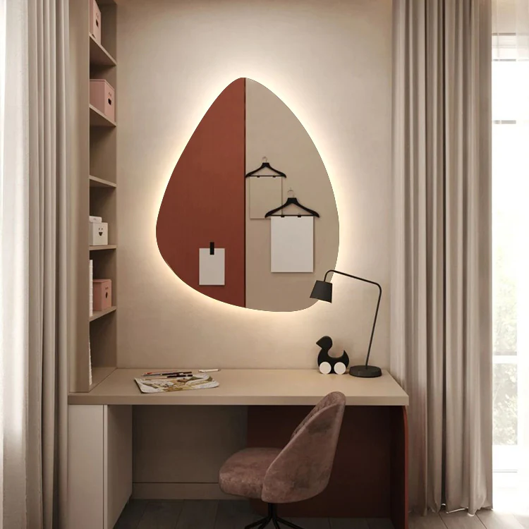 A desk with a mirror, lamp, chair, and shelf.
