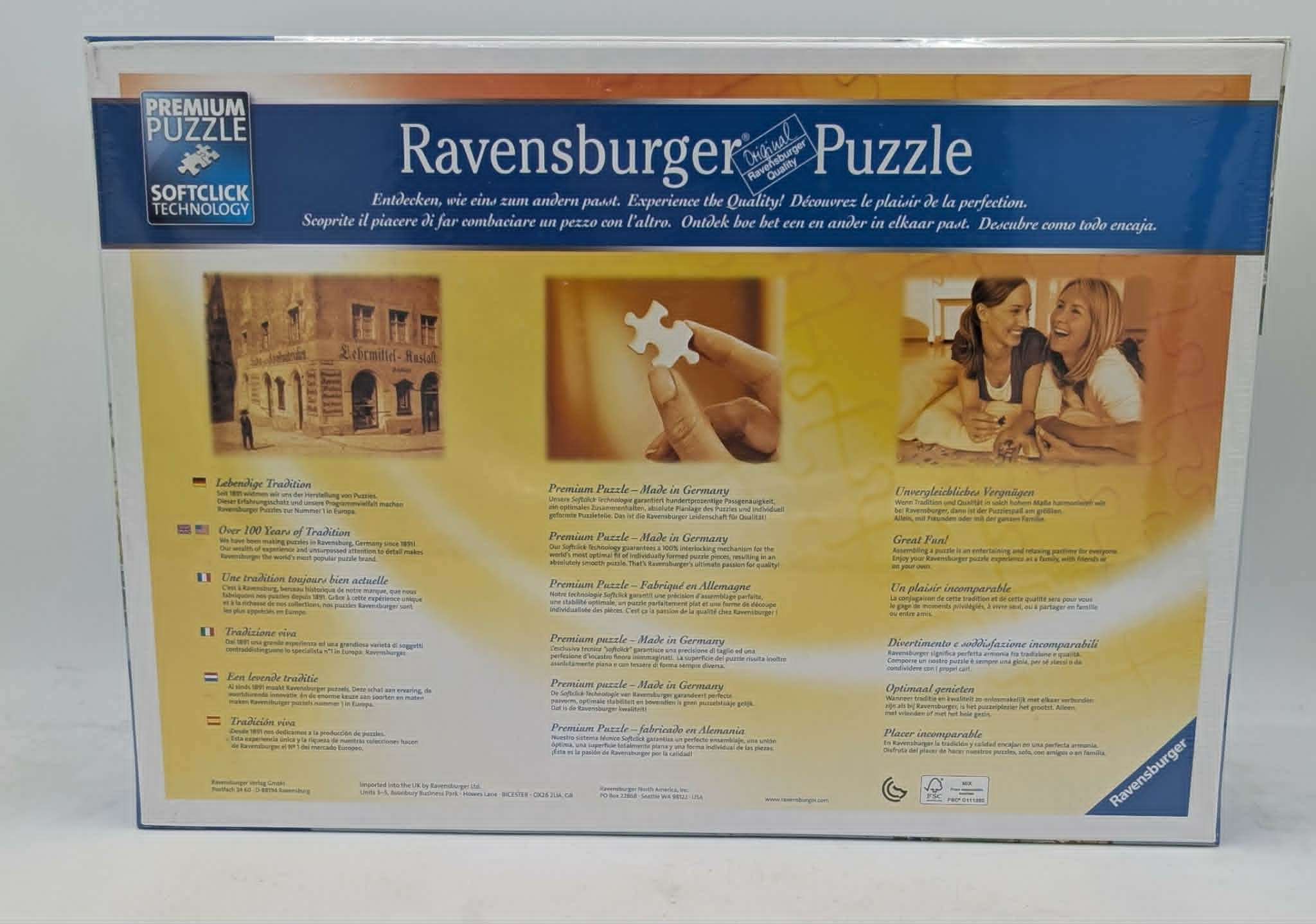 Ravensburger Puzzle-Verpackung mit Bildern von einem Gebäude, einem Puzzleteil und lachenden Frauen.
