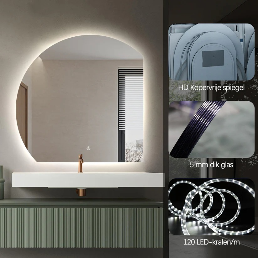 An illuminated round mirror above a white sink and a green cabinet.