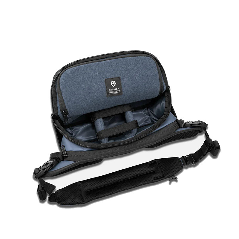 An open blue bag with a black strap and padded shoulder strap.