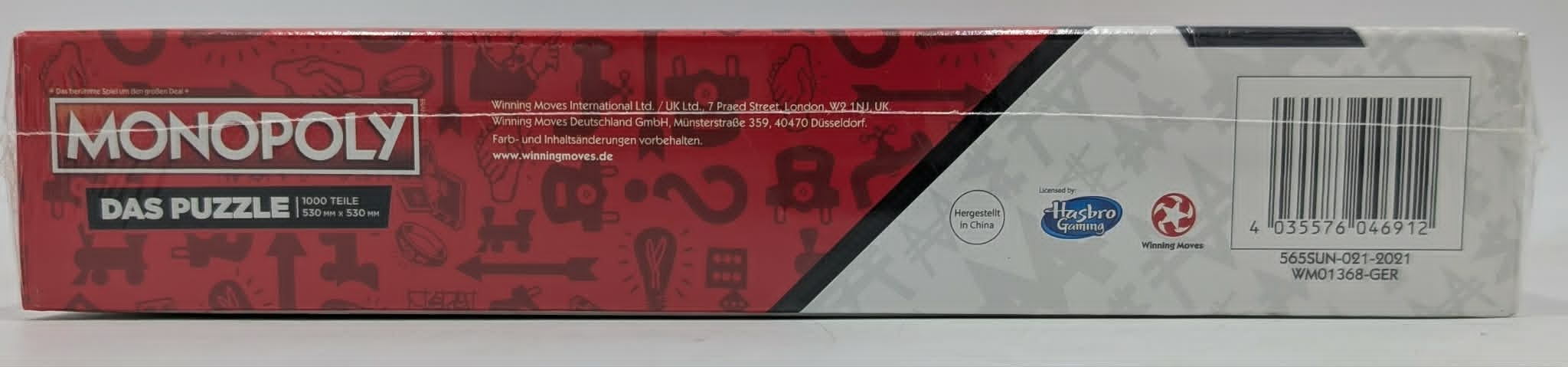 Monopoly Puzzle Box: Roter Karton mit Monopoly-Logo, Spielteilen und Barcode.