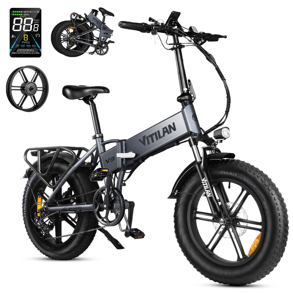 E-bike pieghevole grigia con pneumatici larghi, portapacchi e display.