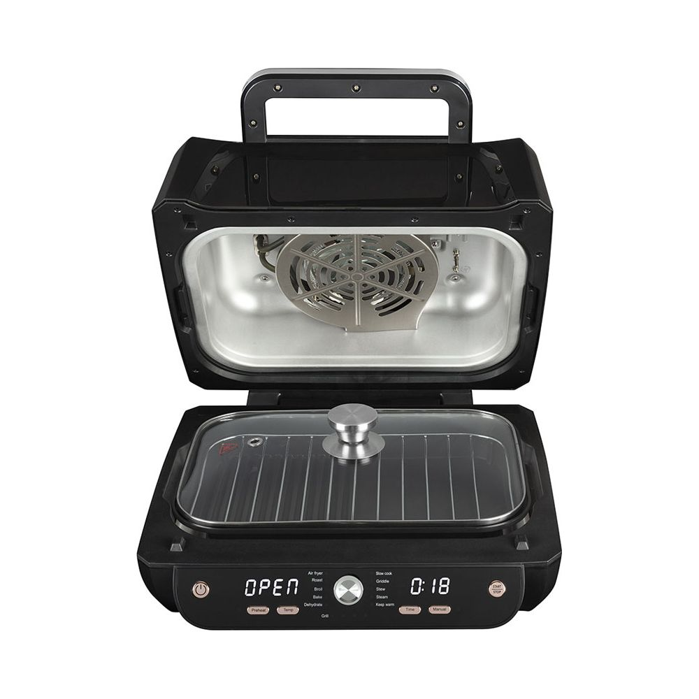 Un grill électrique noir ouvert avec couvercle en verre et fenêtre. Ventilateur à l'intérieur.