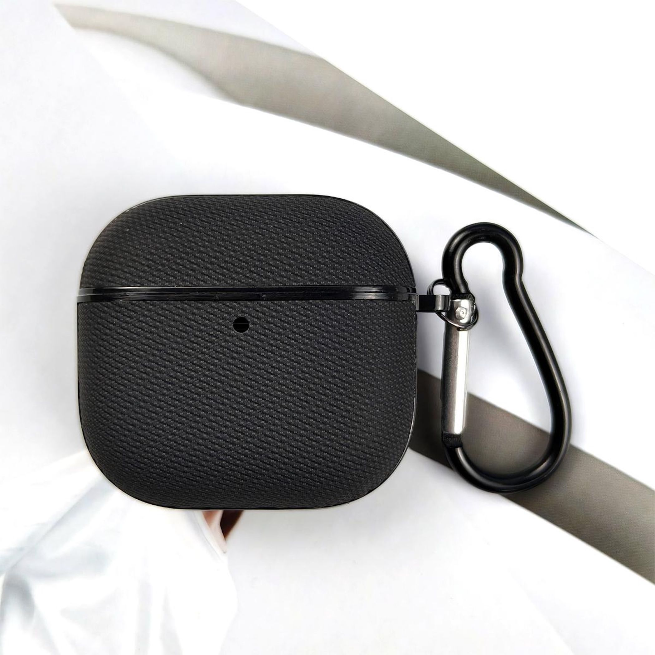 Schwarzes Airpod-Etui mit Karabinerhaken auf weißem Hintergrund.