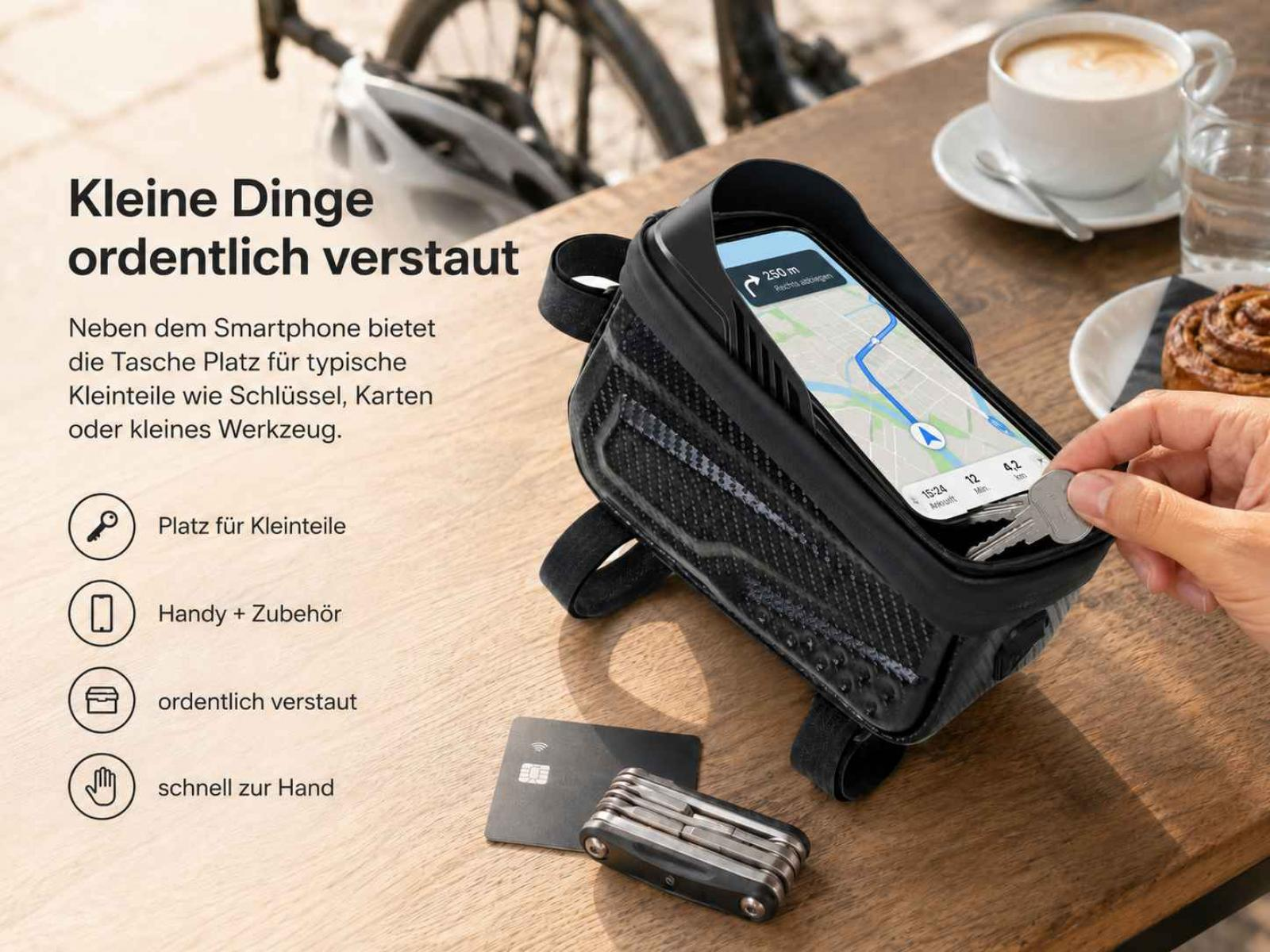 Eine schwarze Fahrradtasche mit Smartphone, Schlüsseln, Werkzeug und Kreditkarte.