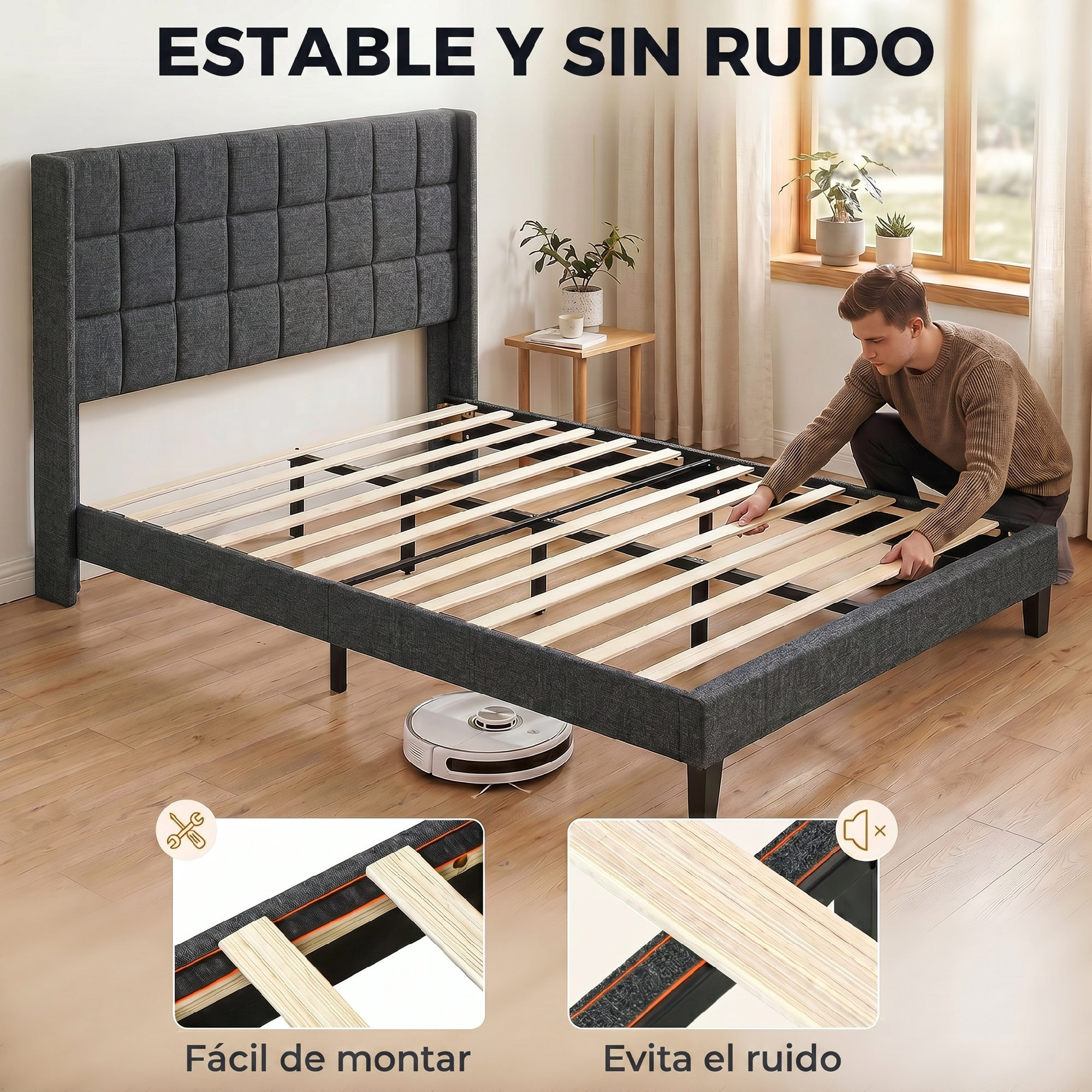 Hombre montando somier de láminas de madera, aspiradora robot cerca.