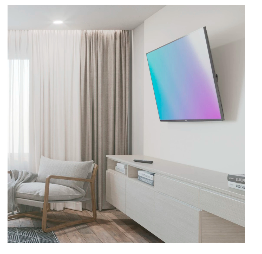Un soggiorno moderno con poltrona, TV e credenza.