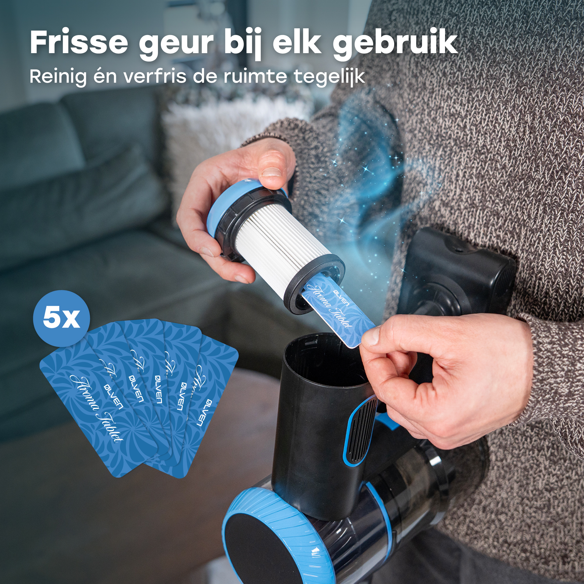 A hand inserts an aroma tablet into a vacuum cleaner filter.