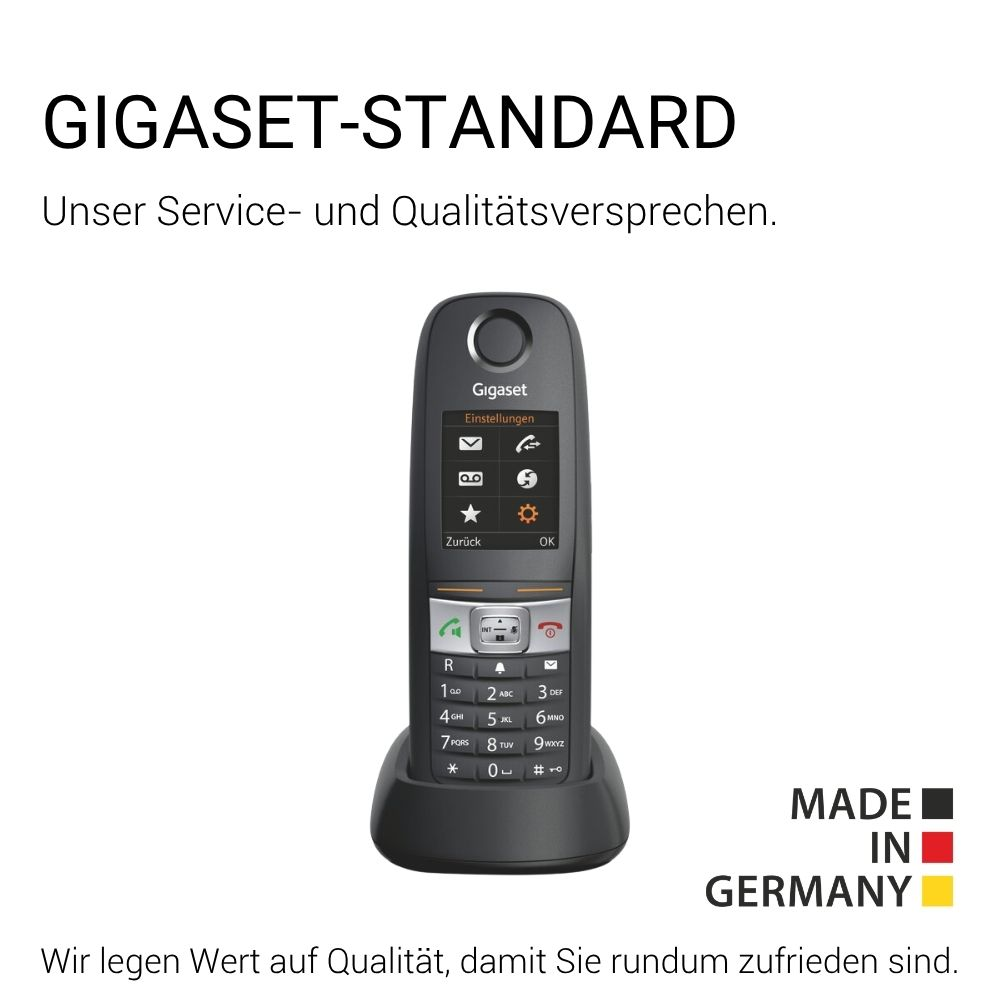 Un telefono Gigaset grigio con tastiera e schermo è in una base di ricarica.