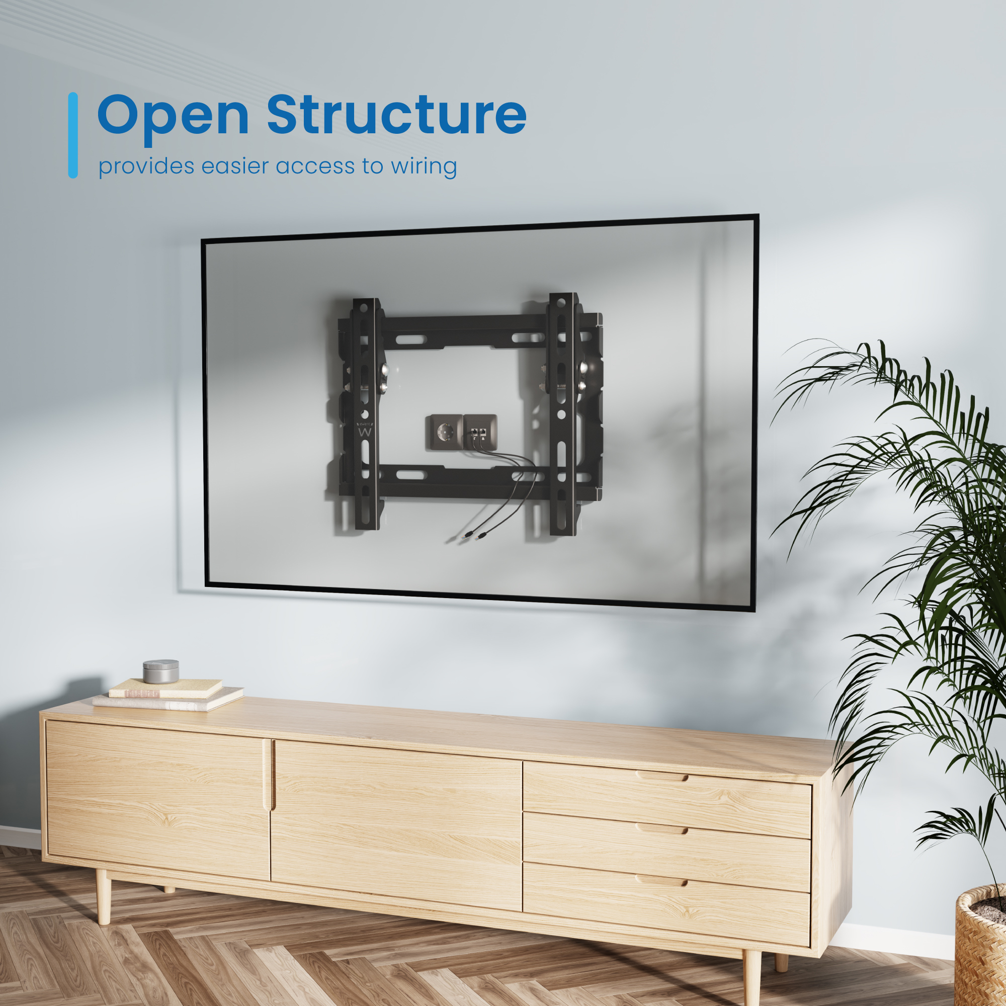 Ein schwarzer TV-Wandhalter mit Kabeln ist an einer Wand montiert.