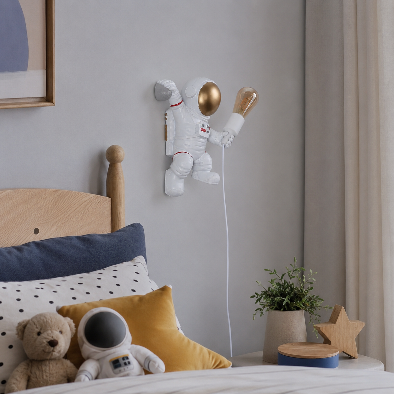 Una luz de pared de astronauta con casco dorado cuelga sobre una cama con osito y almohadas.