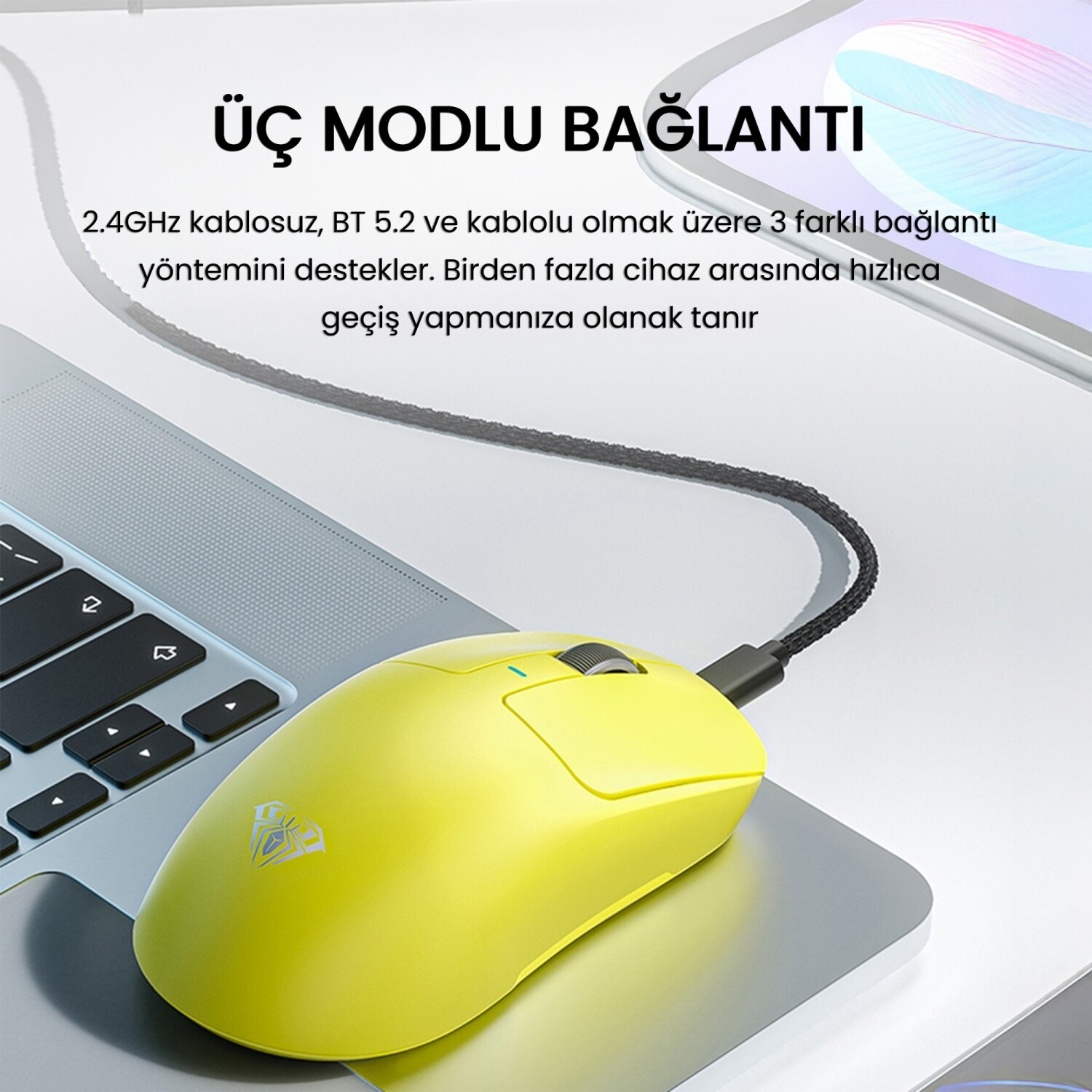 Sarı fare kablolu, dizüstü bilgisayar klavyesinde, üç bağlantı modu hakkında metin.
