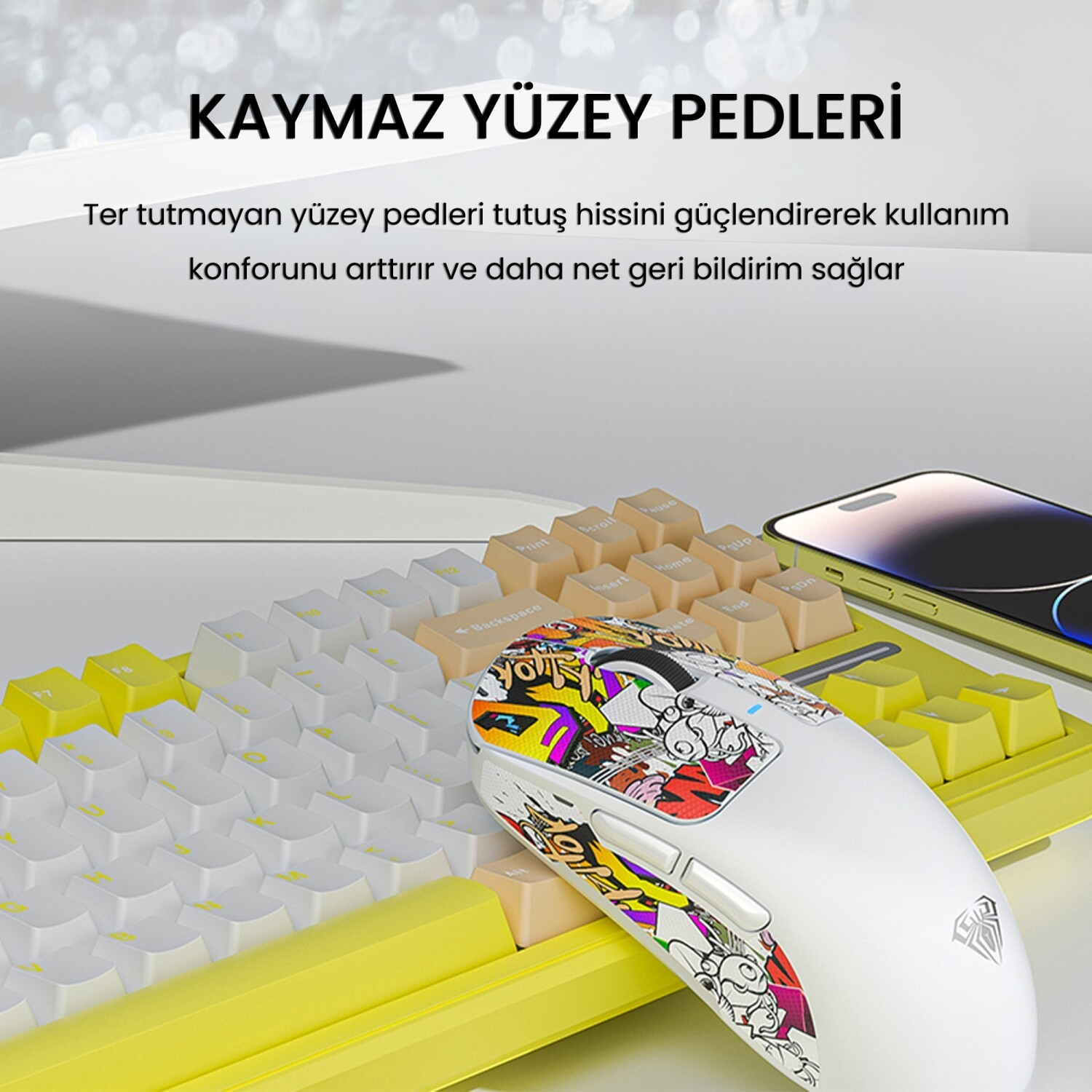 Sarı kasalı klavye üzerinde grafitili beyaz fare.