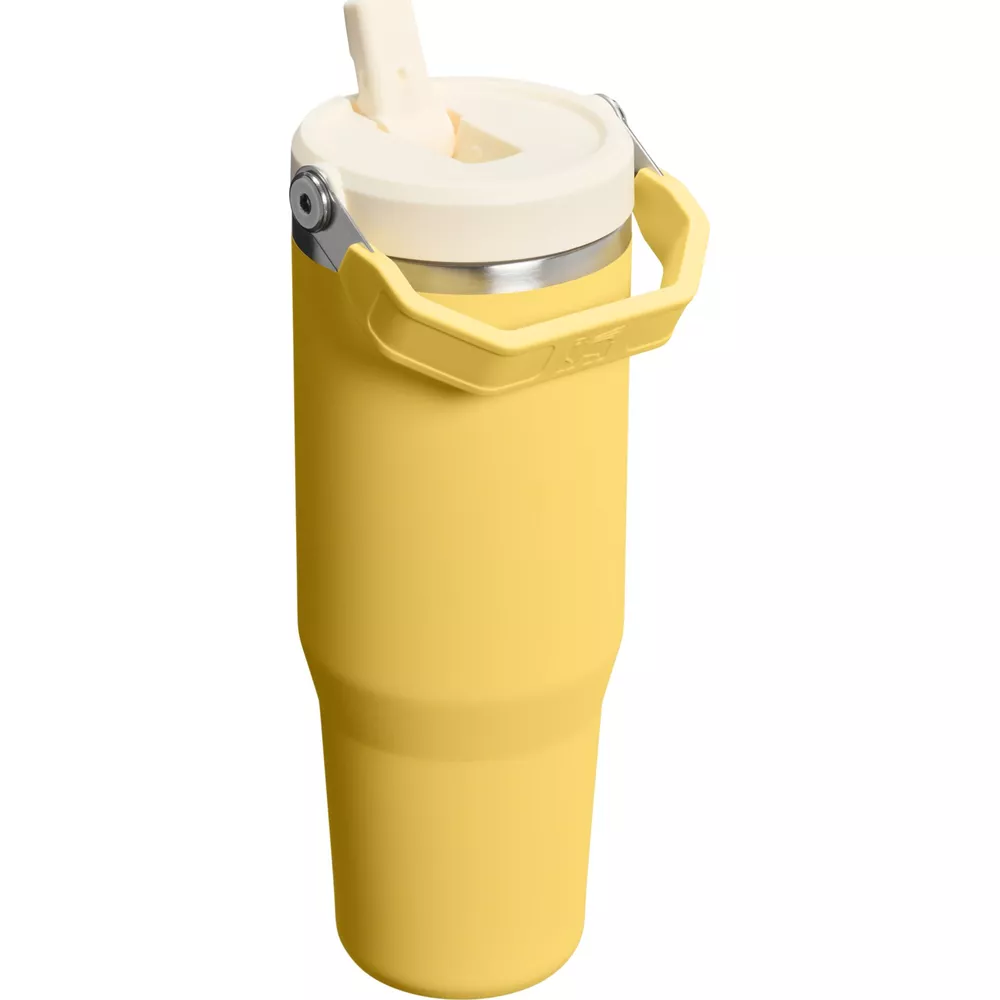 Gümüş saplı, beyaz kapaklı ve pipetli sarı bardak.