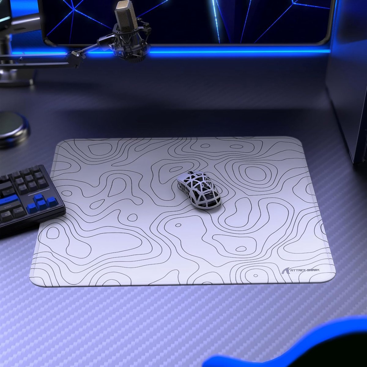 A white mouse rests on a black-lined topographic map. A keyboard is to the left.