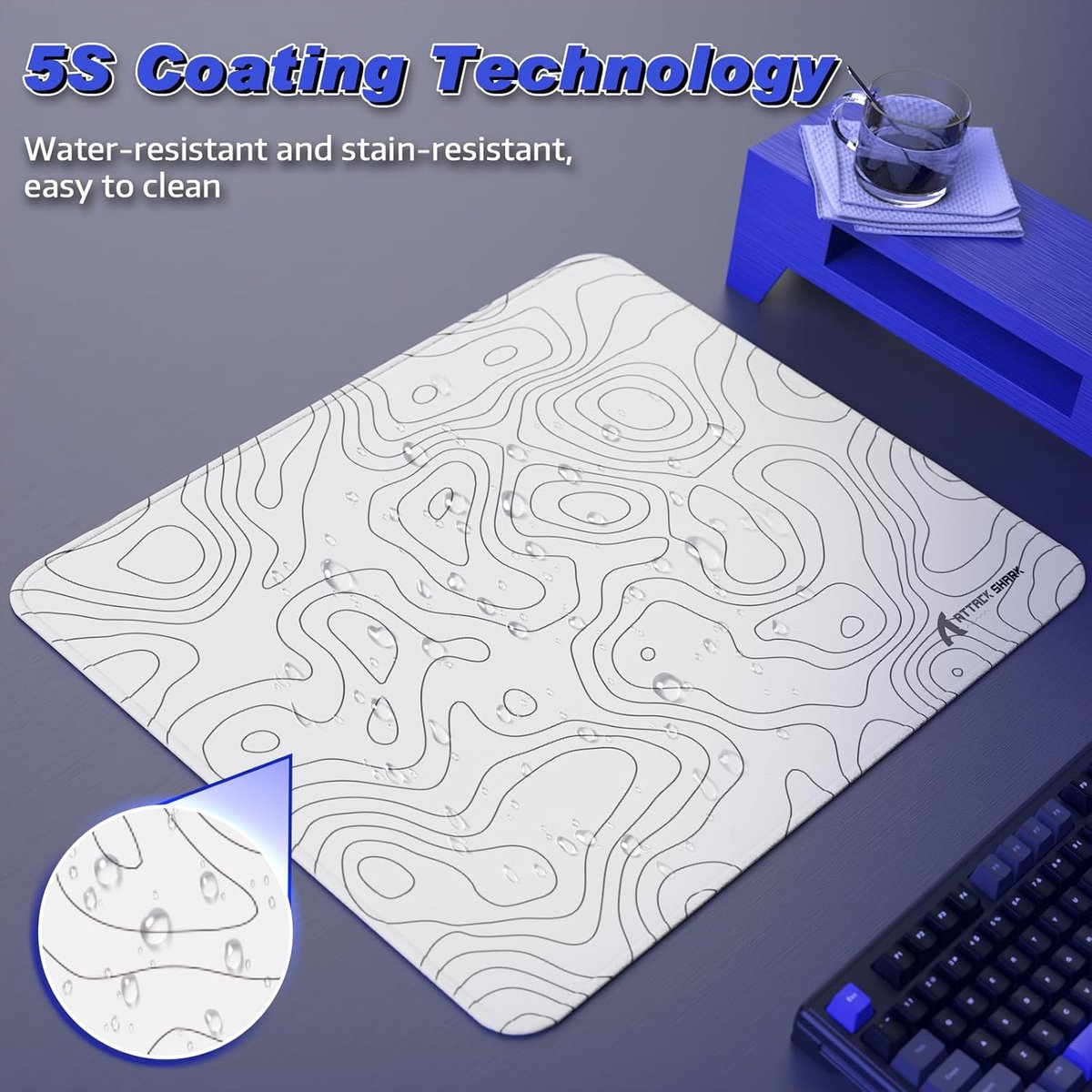 White mousepad with black lines, water drops. Keyboard in background.