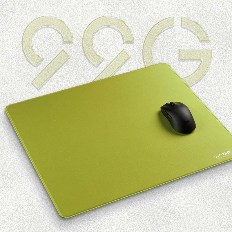 A black computer mouse rests on a lime green mousepad. Faint letters are in the background.