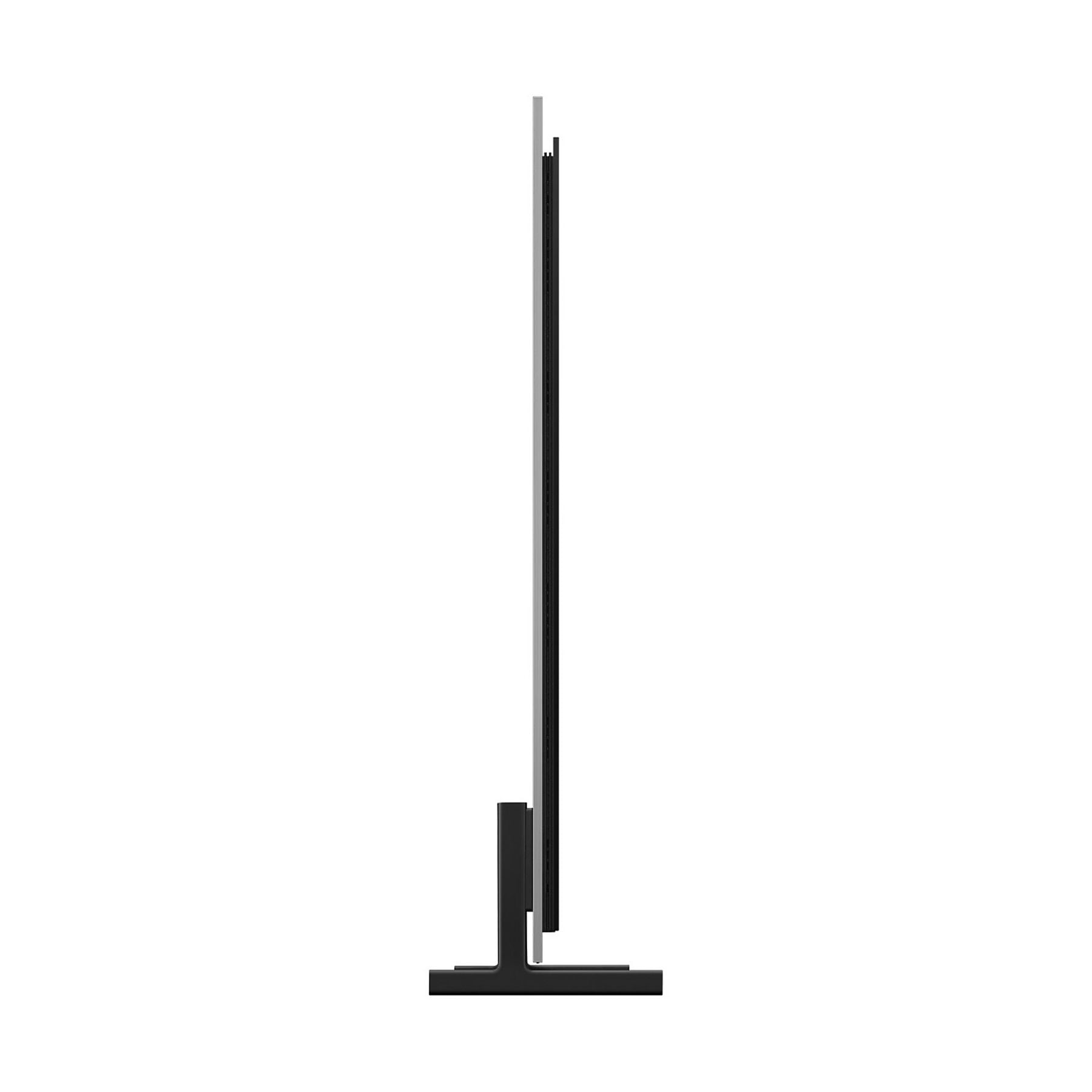 Una TV nera e sottile poggia su una base a forma di T.