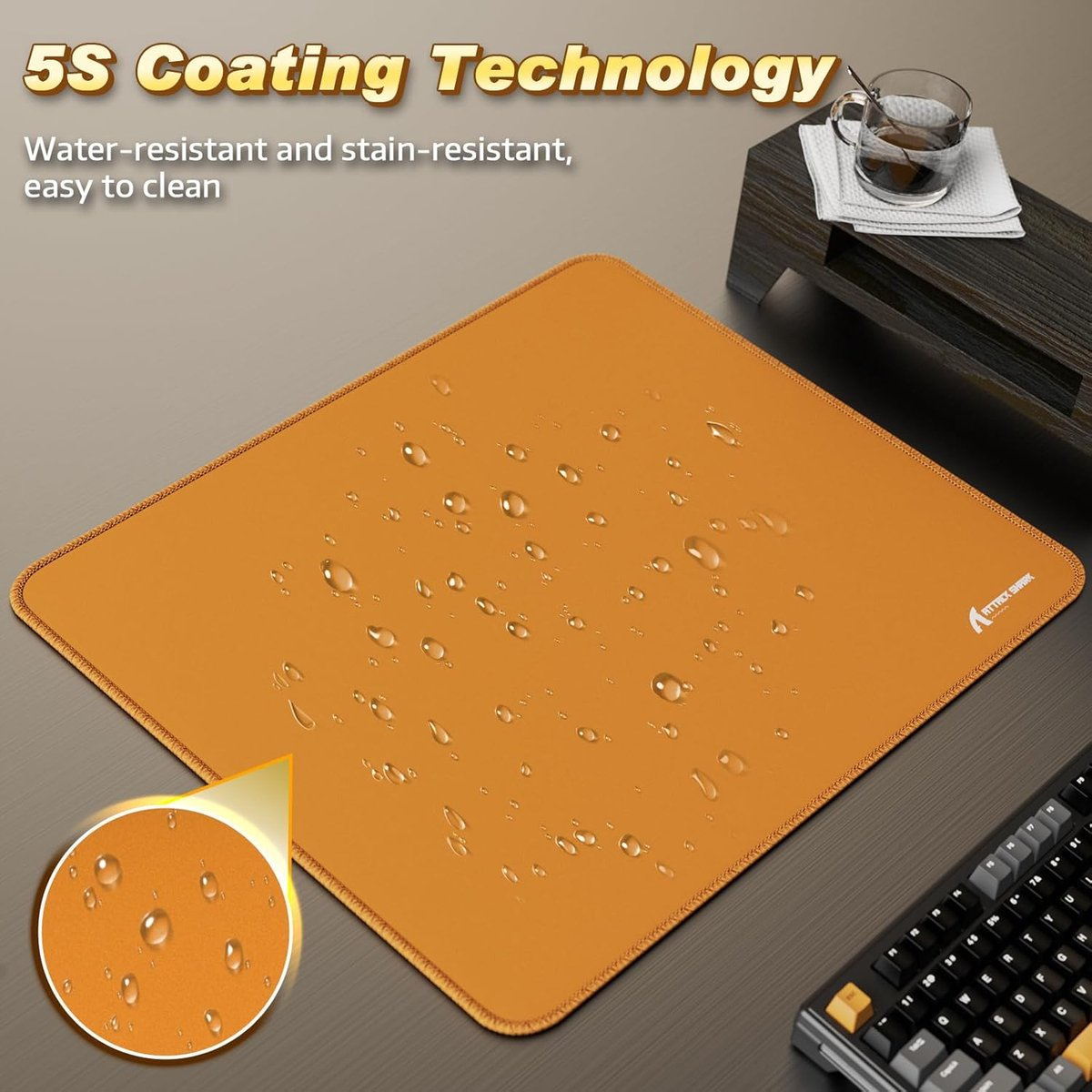 Orange mousepad with water drops, keyboard and coffee cup in background.