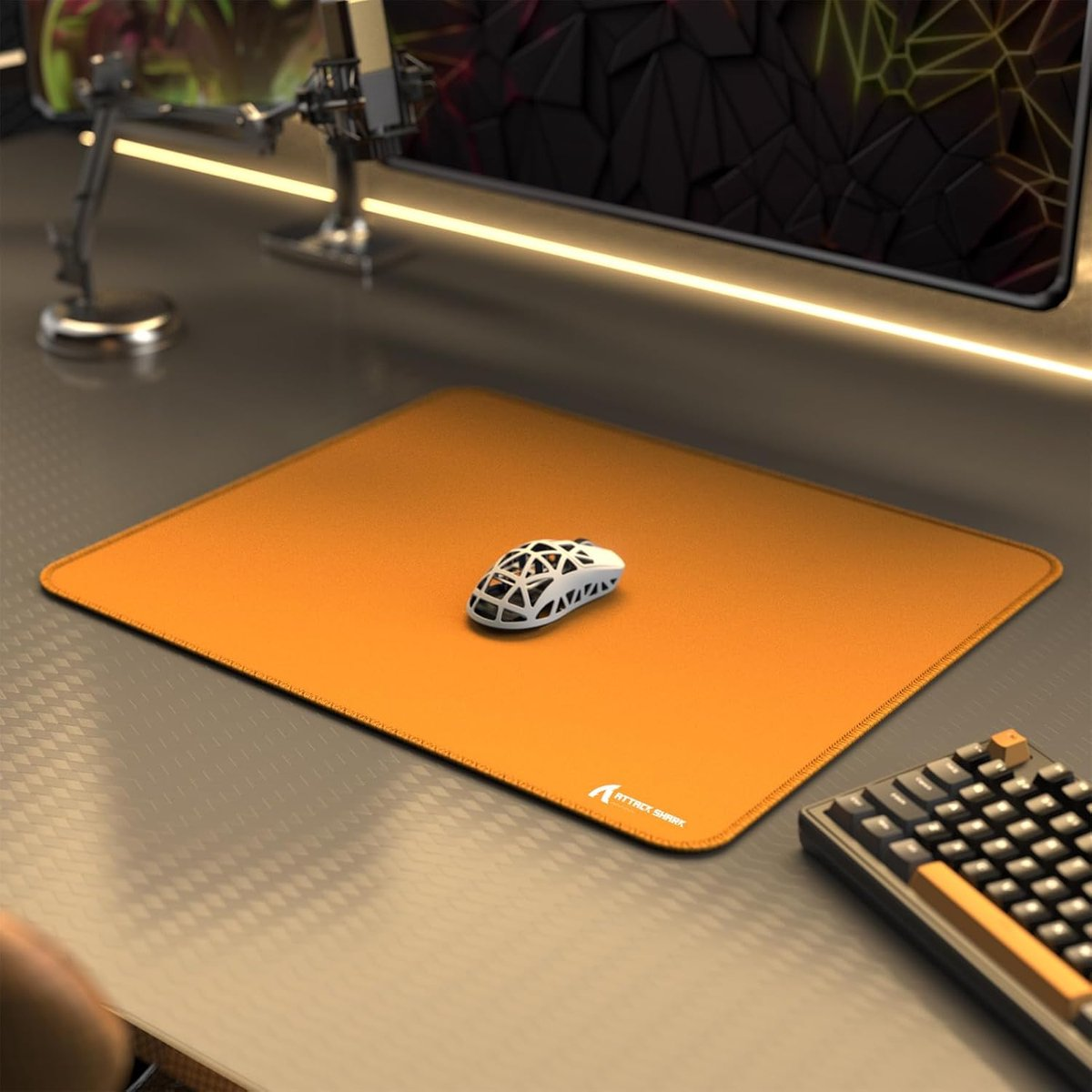 An orange mousepad with a white mouse and keyboard on a desk.