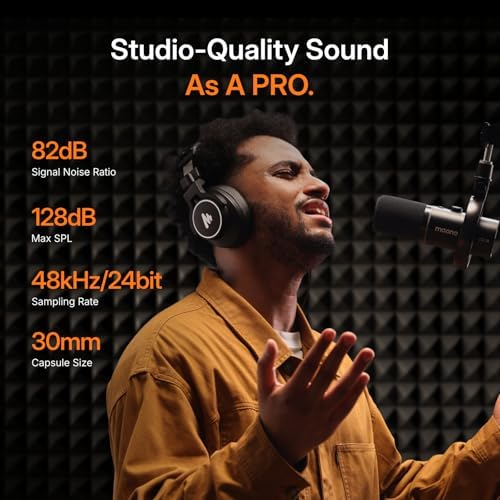 Man wearing headphones and microphone, studio acoustics in background.