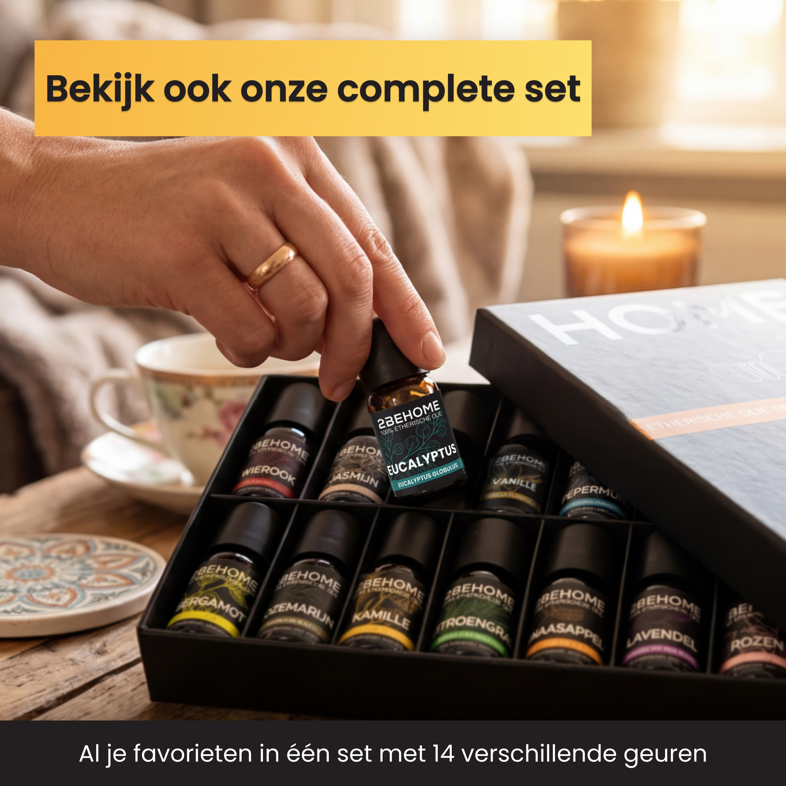 A hand holds an essential oil bottle over a box of small bottles.