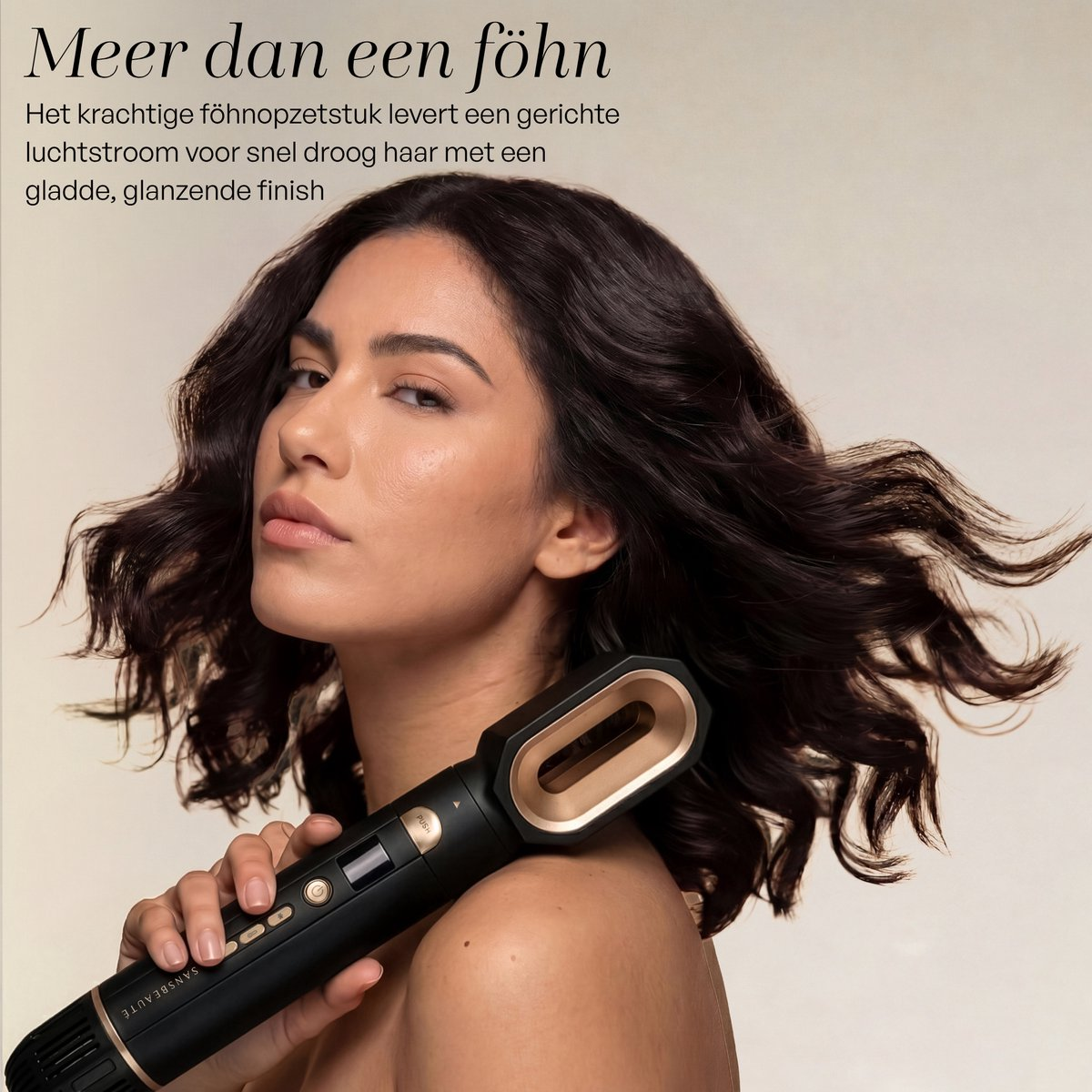 Woman holding a black hair dryer attachment with gold accents.