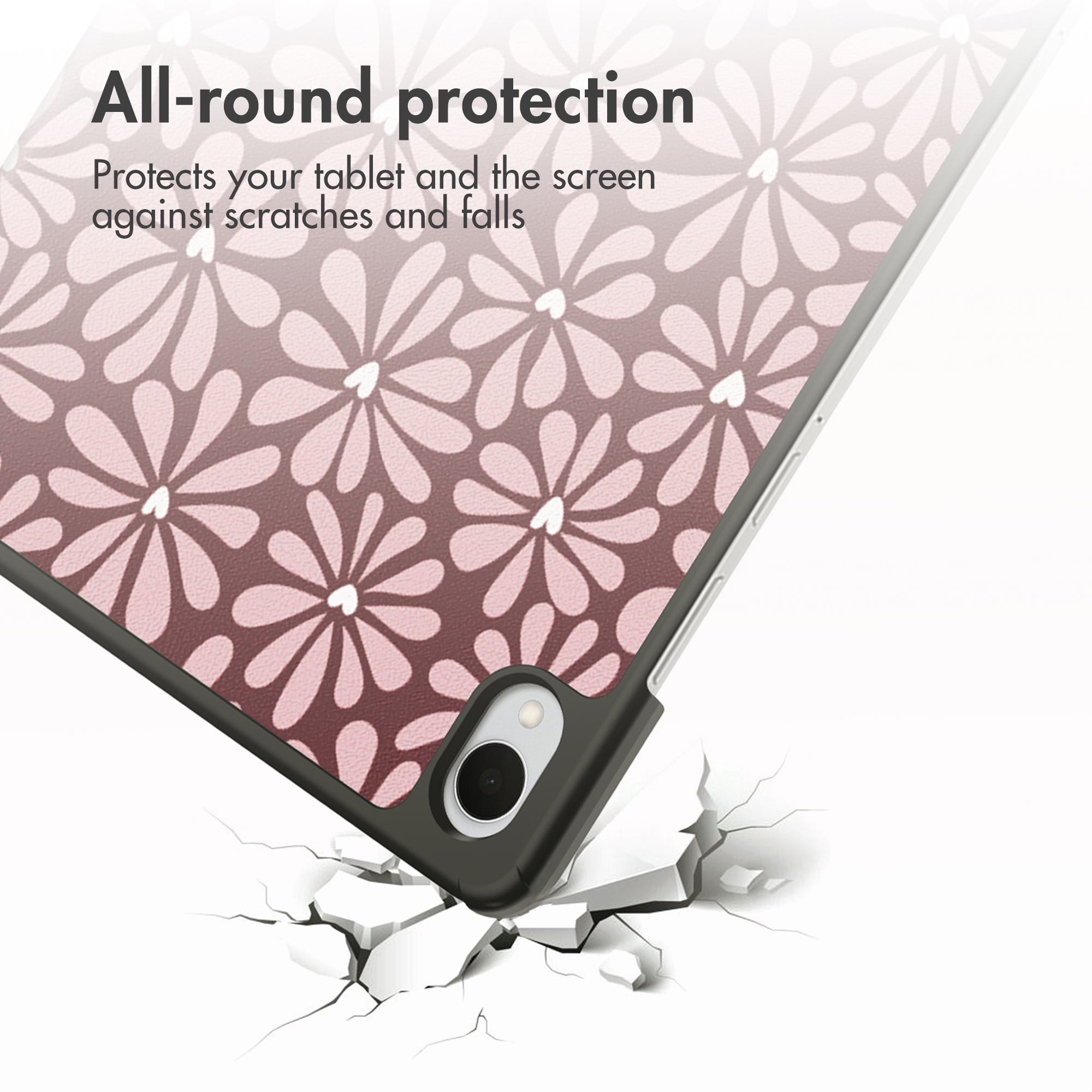 A tablet with a floral pattern falls onto cracked ground.