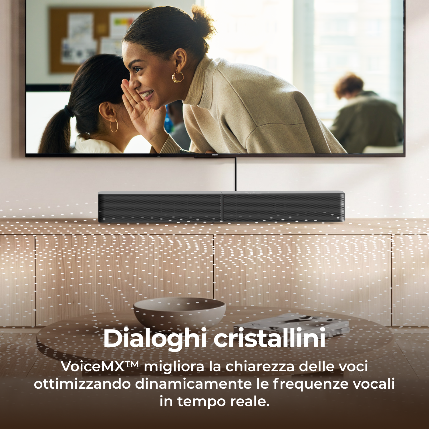 Una donna sussurra all'orecchio di un'altra sullo schermo TV.