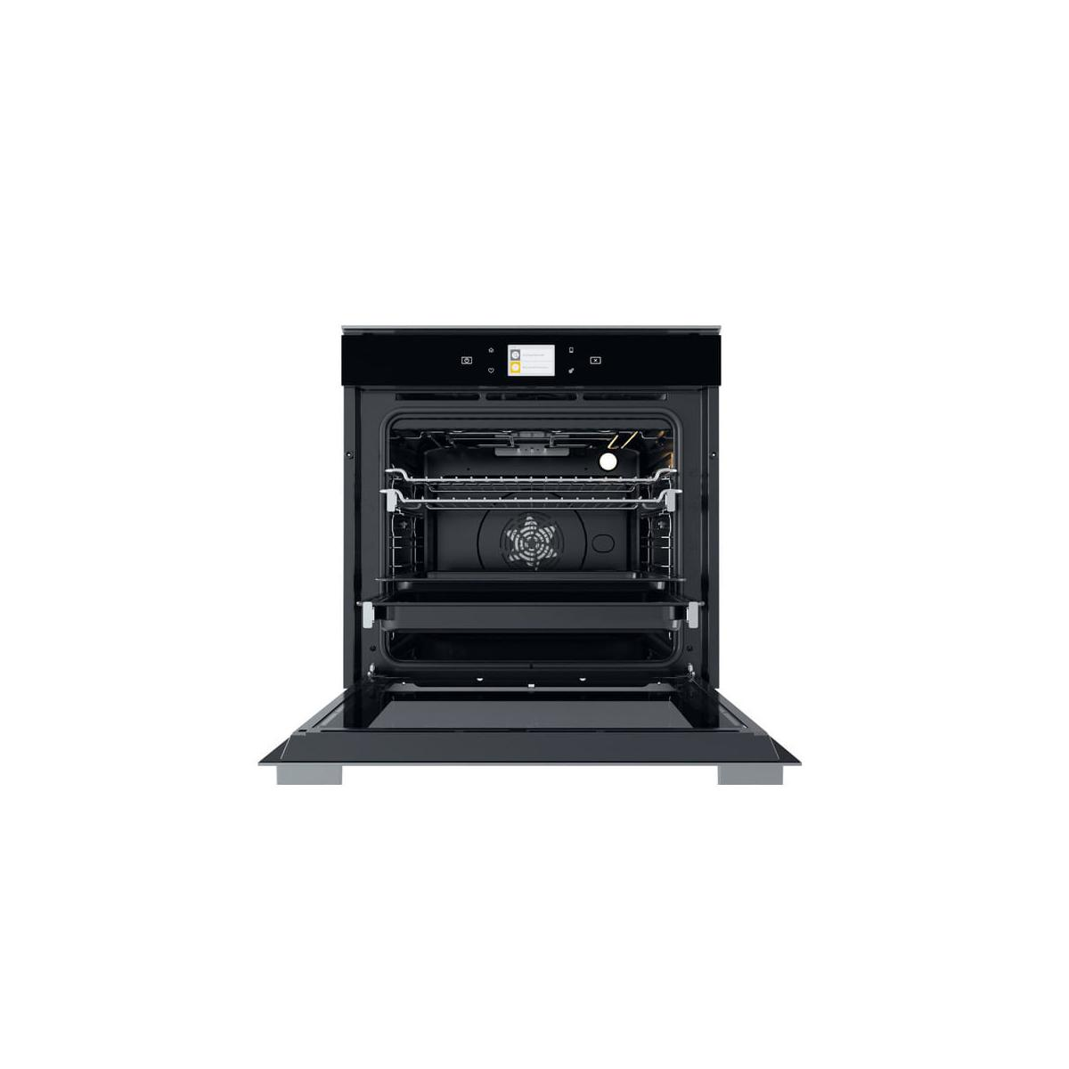 Un forno da incasso moderno con porta aperta, pannello nero.