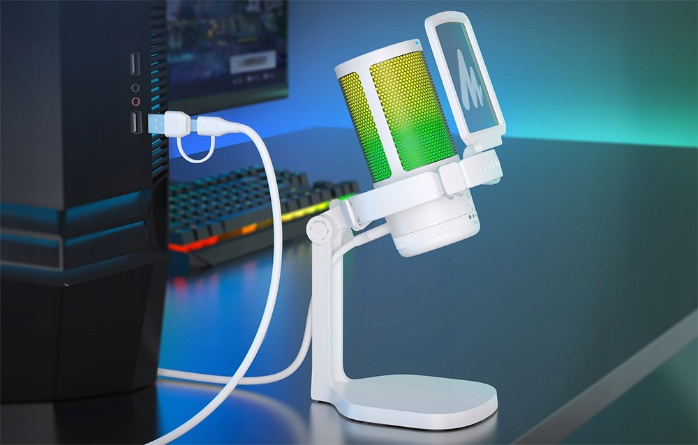 A white microphone with a color gradient, connected to a PC, next to a keyboard.