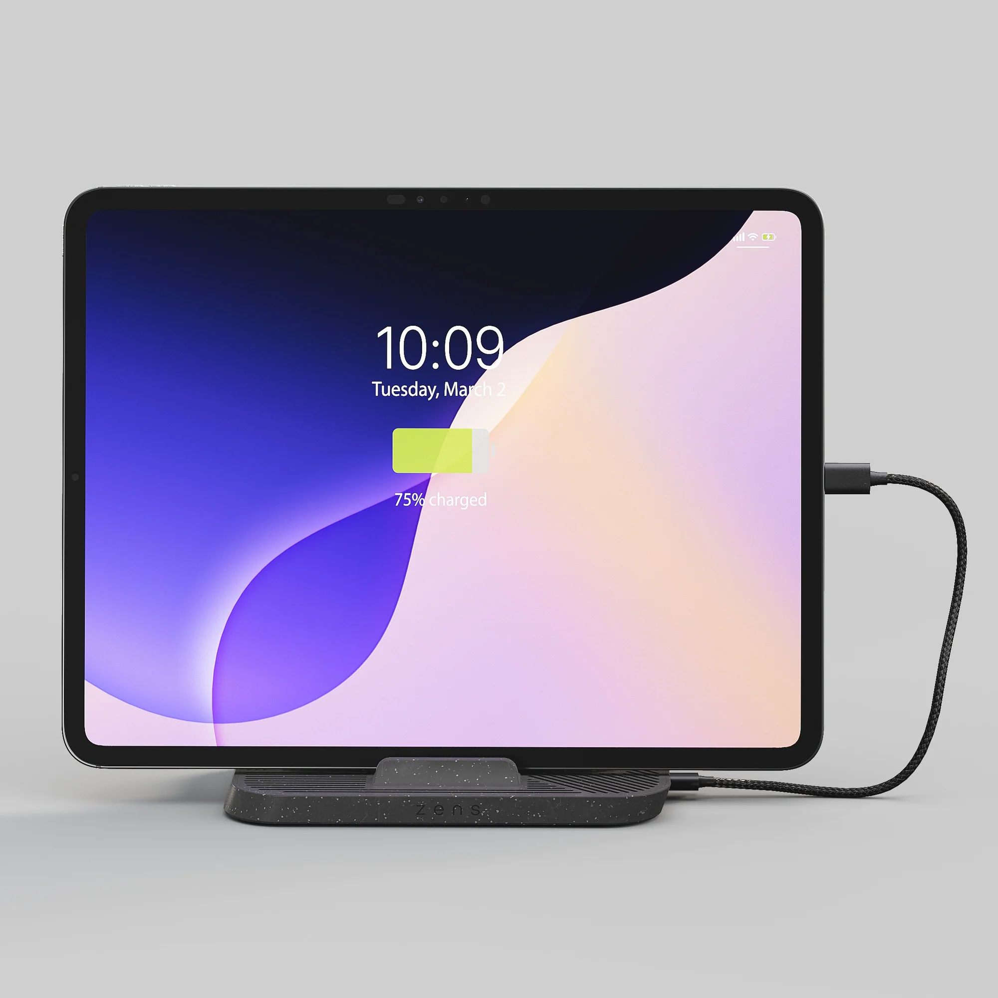Ein Tablet mit einem bunten Hintergrund, das auf einem Ladegerät steht.