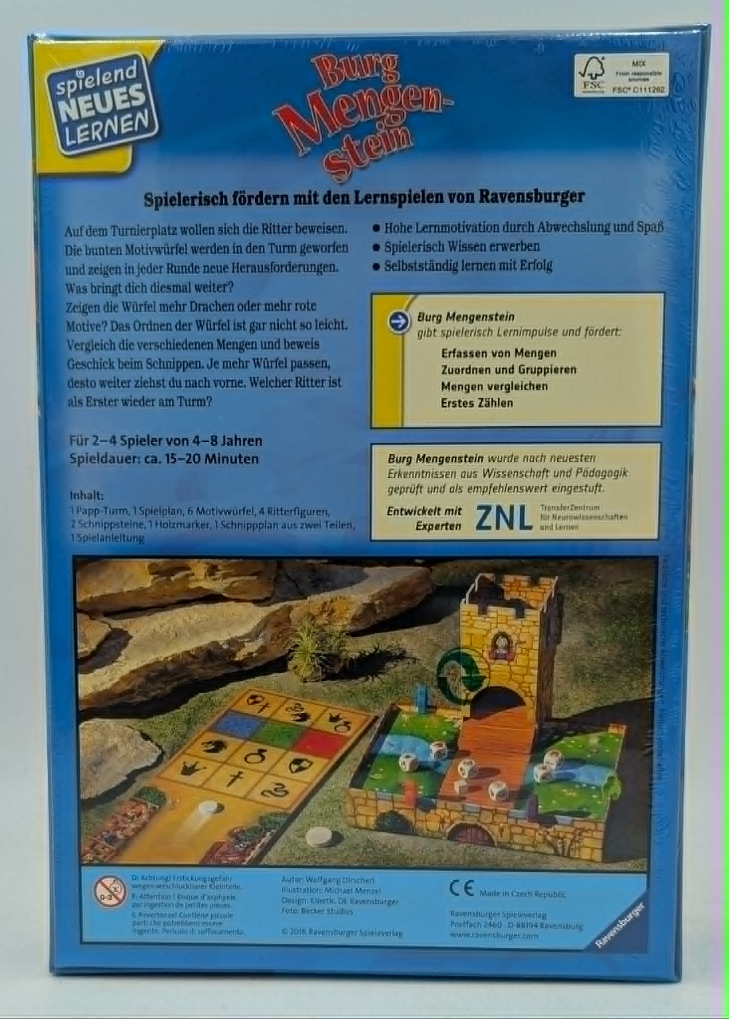 Spielverpackung mit Burg, Spielbrett und Würfeln. Fördert spielerisch Lernen.