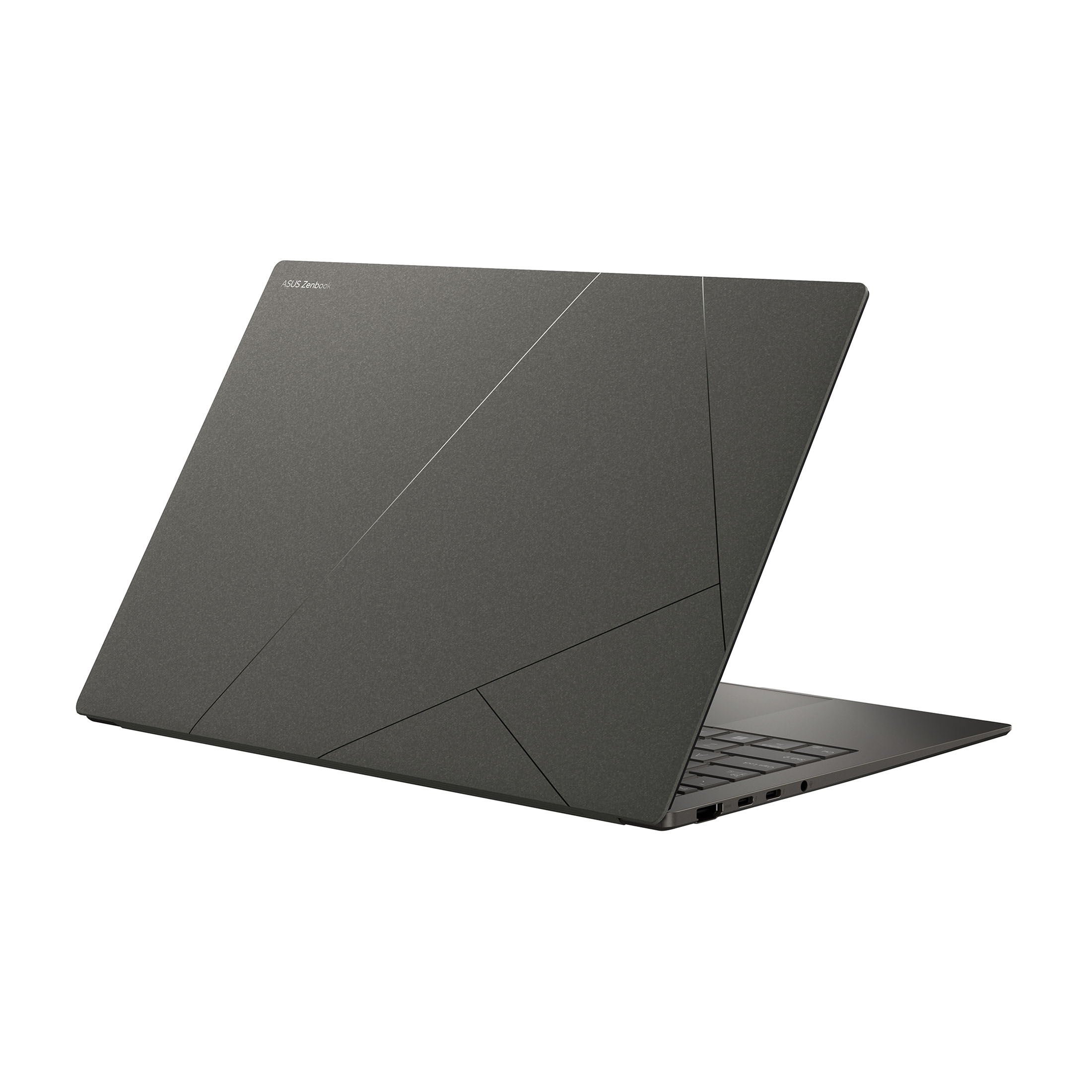 Ein geschlossener, dunkler Laptop mit Asus Zenbook-Logo und geometrischem Design.