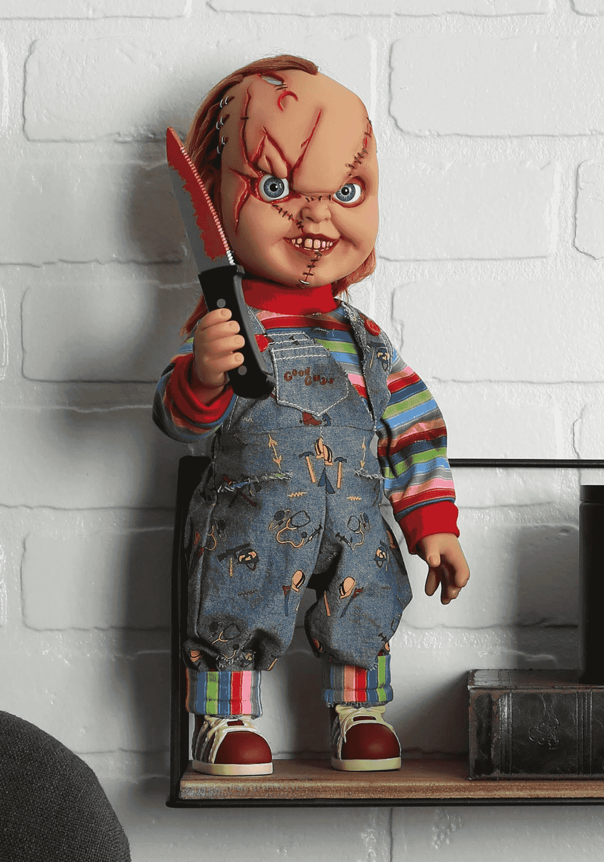 Una muñeca con cicatrices y un cuchillo ensangrentado, vestida con overol.