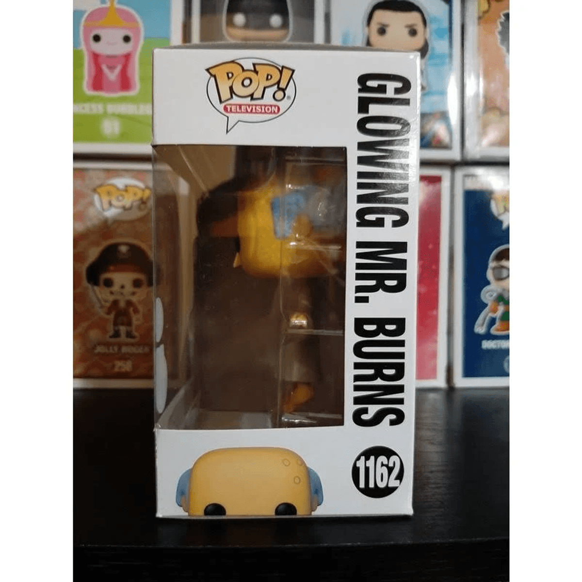 Figura Pop! de Mr. Burns en caja, con cuerpo amarillo y orejas azules.