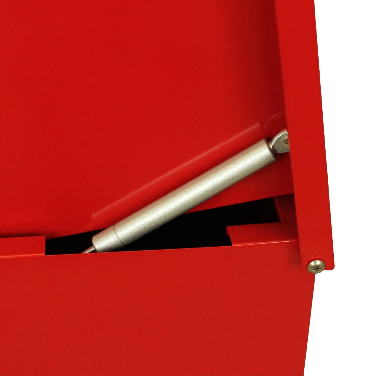Un amortiguador de gas plateado está unido a una caja de metal roja.