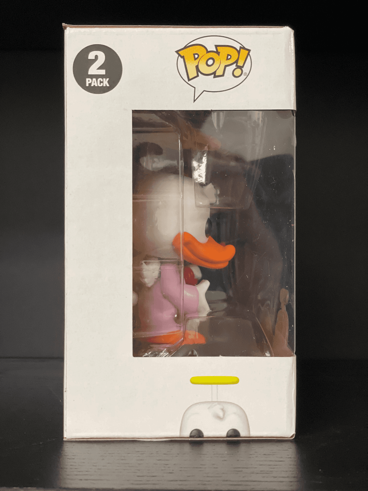 Ein Funko Pop! 2er-Pack mit einer Ente im rosa Kleid und einem gelben Heiligenschein-Detail.